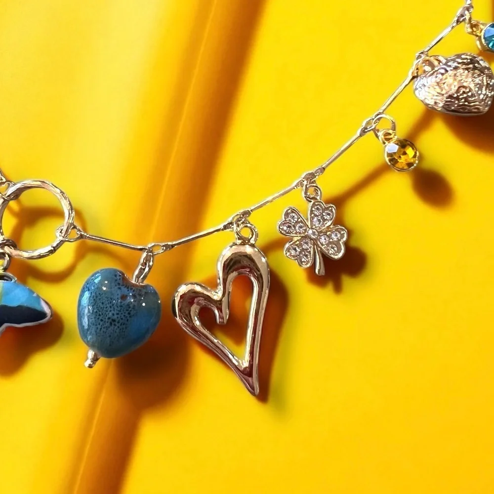 Unique and Gorgeous Gold toned Necklace with Varying Blue and Yellow Charms